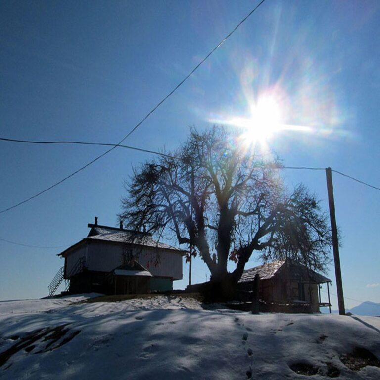 Bijli Mahadev Temple in Kullu Valley, Himachal Pradesh with snow-covered landscape and bright sunlight